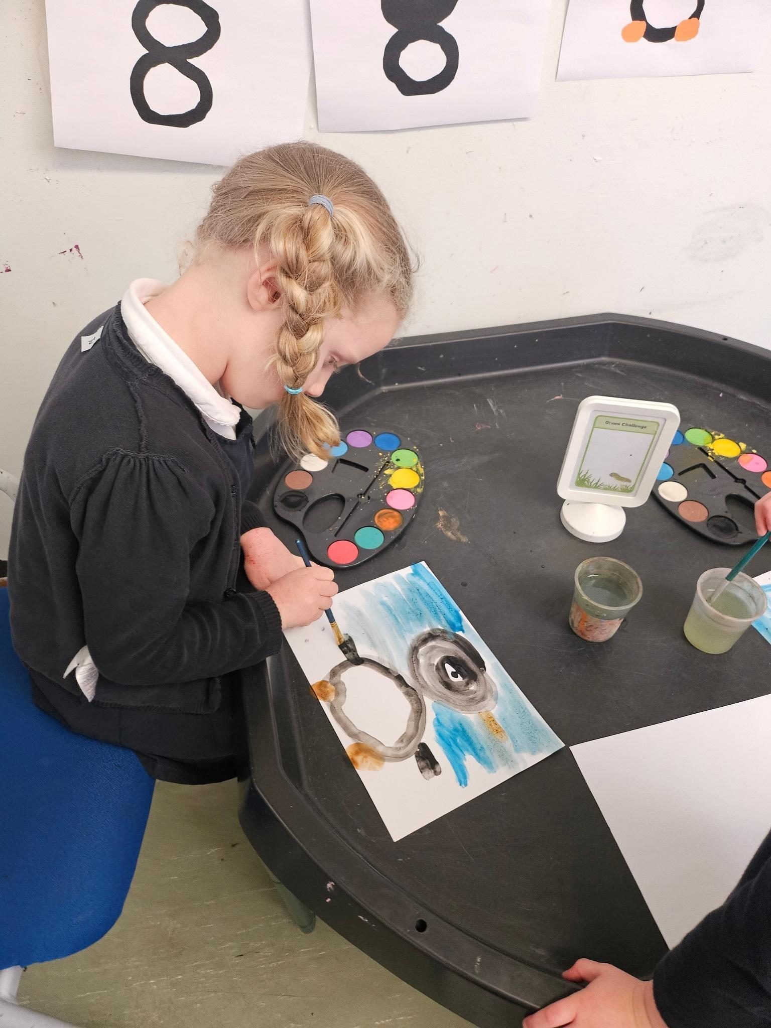 Pupil painting during a creative classroom activity