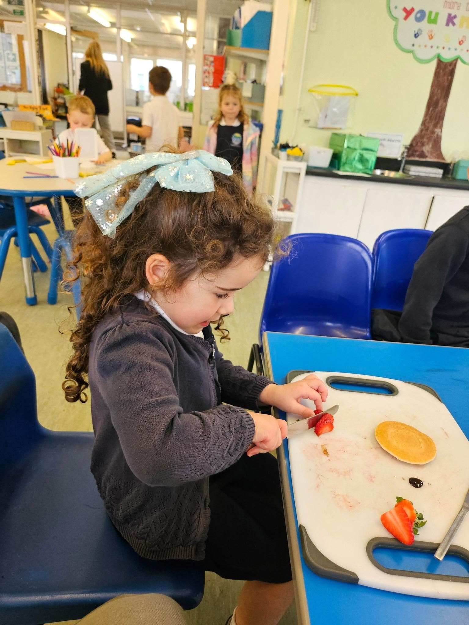 Pupil preparing fruit during a classroom activity