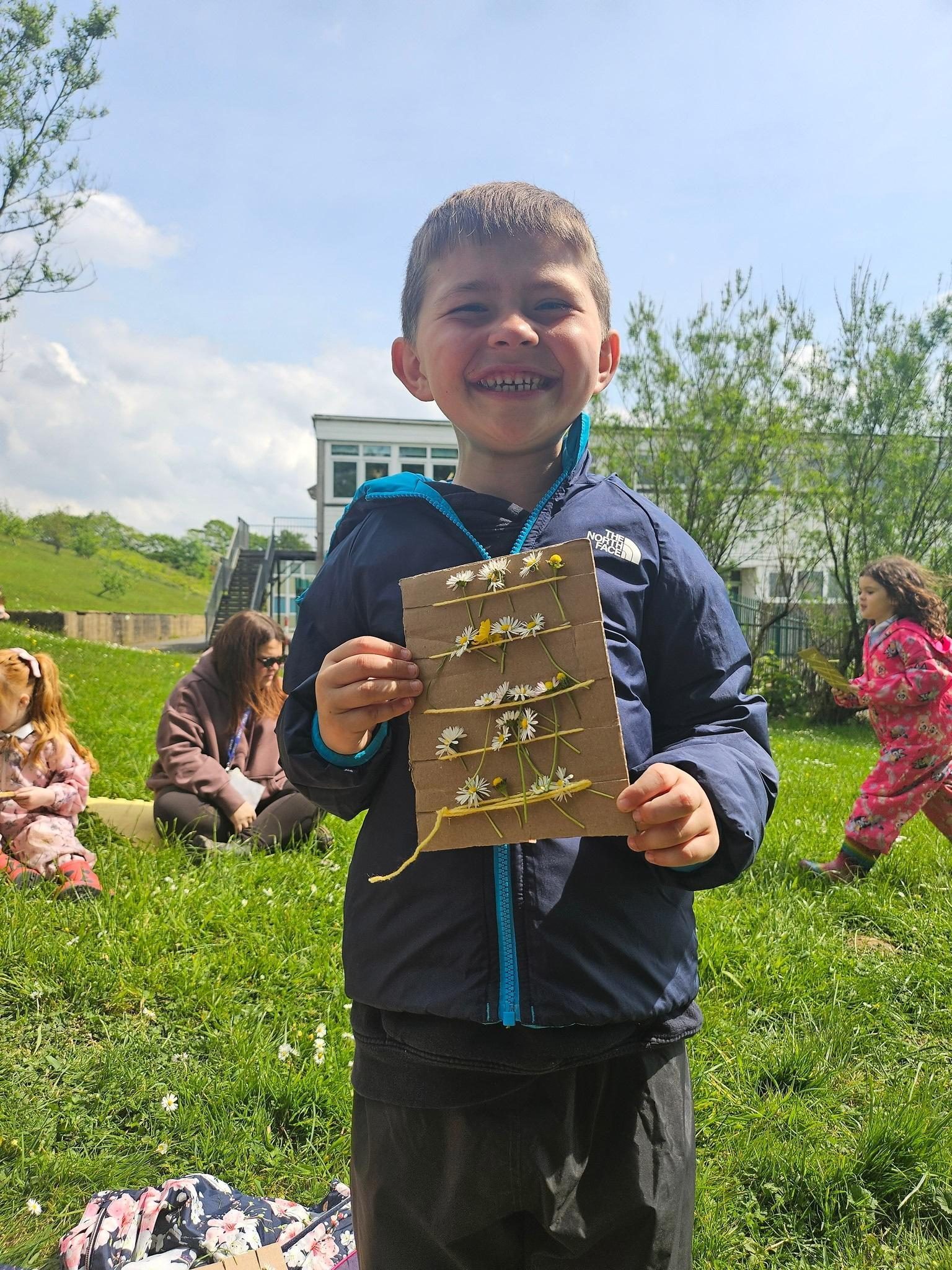 Pupil holding a nature craft
