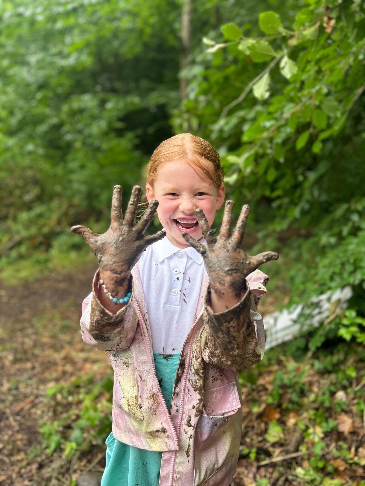 Pupil enjoying a muddy outdoor activity