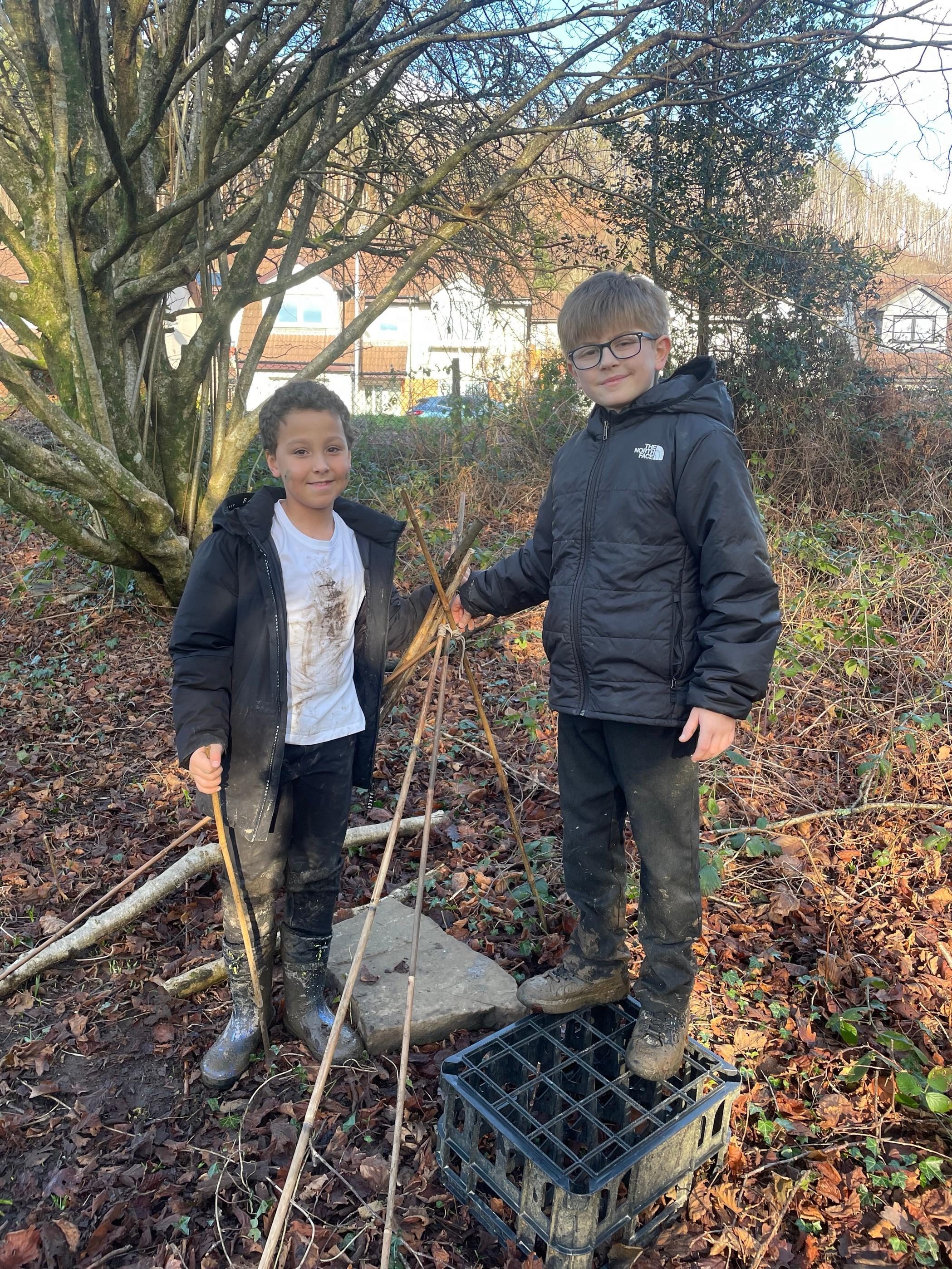 Pupils building together outdoors