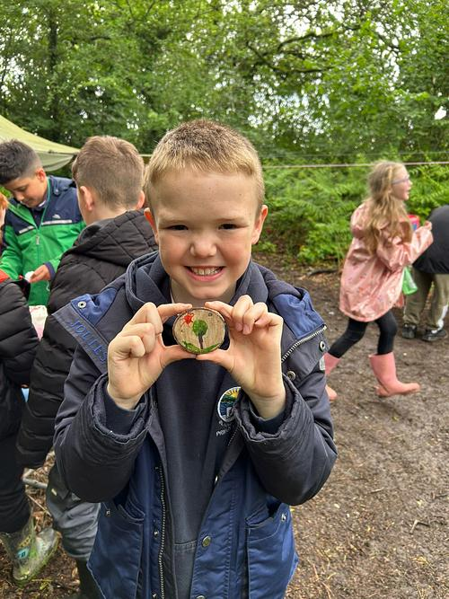 Pupil holding a woodland nature creation