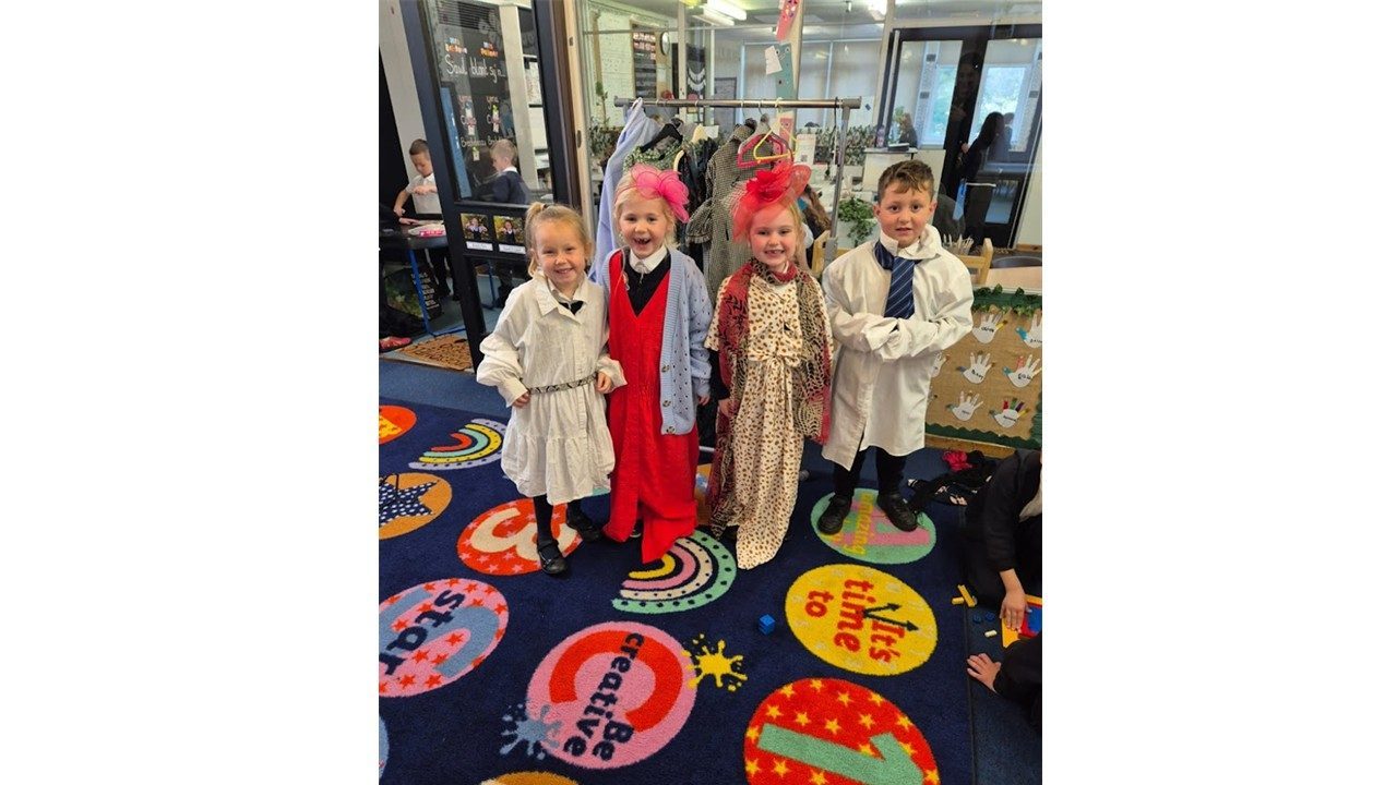 Children smiling together while dressed as story characters