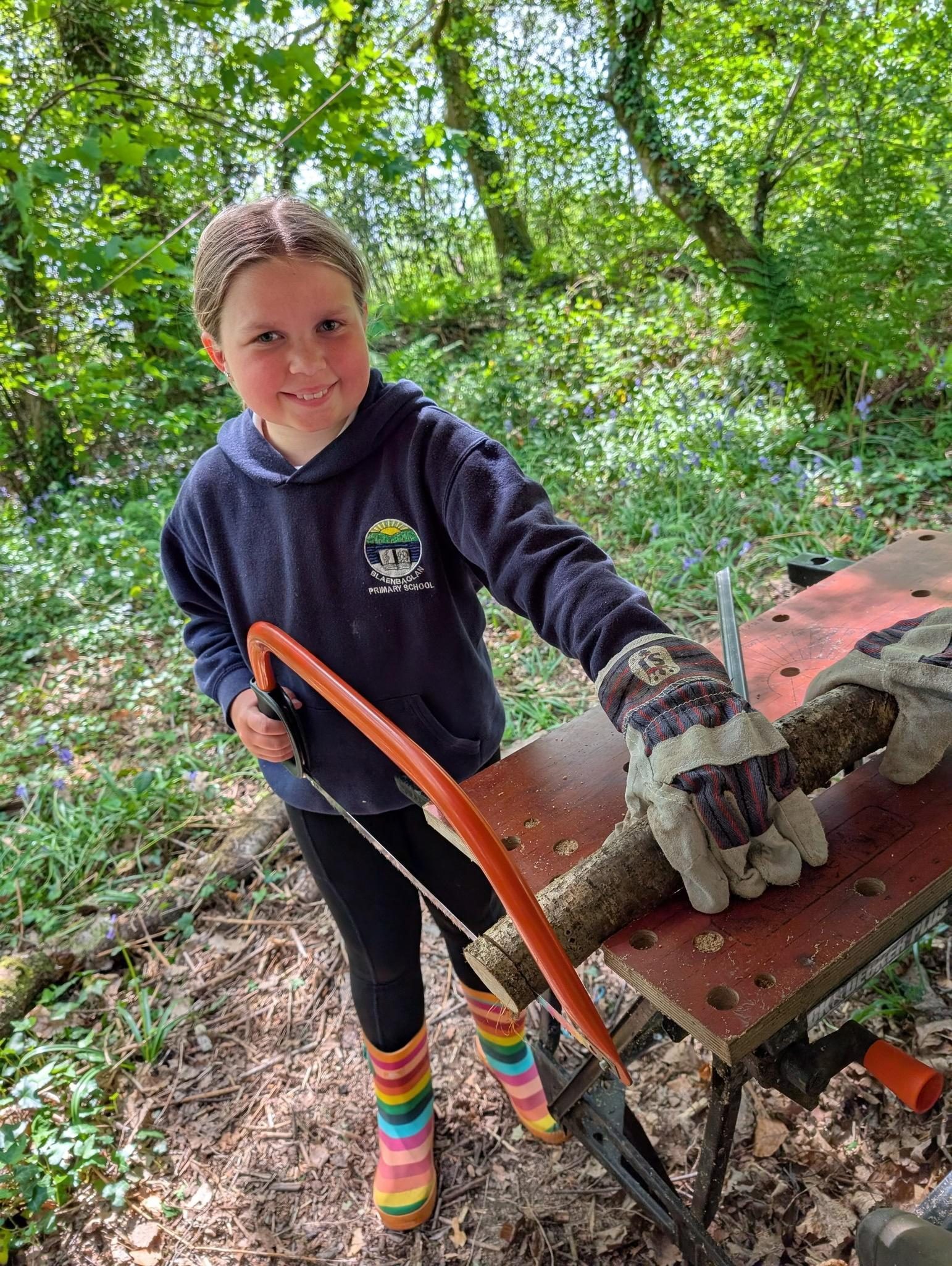 Pupil learning to use tools safely outdoors