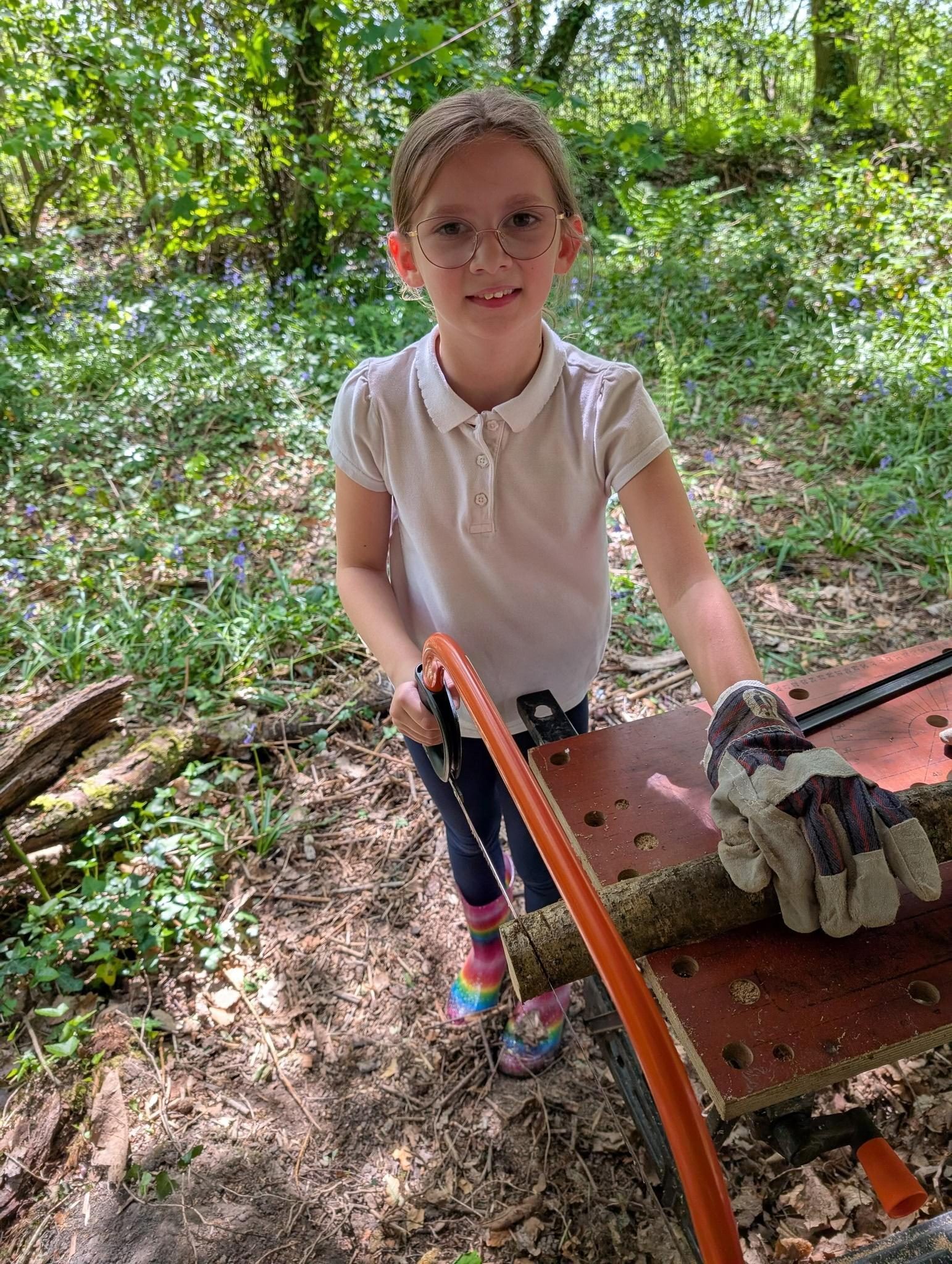 Pupil using hand tools safely during a woodland activity