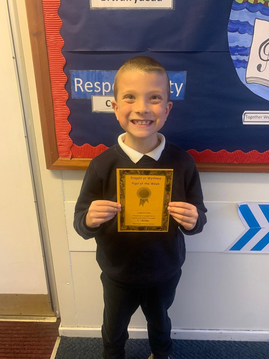 Pupil proudly holding a certificate